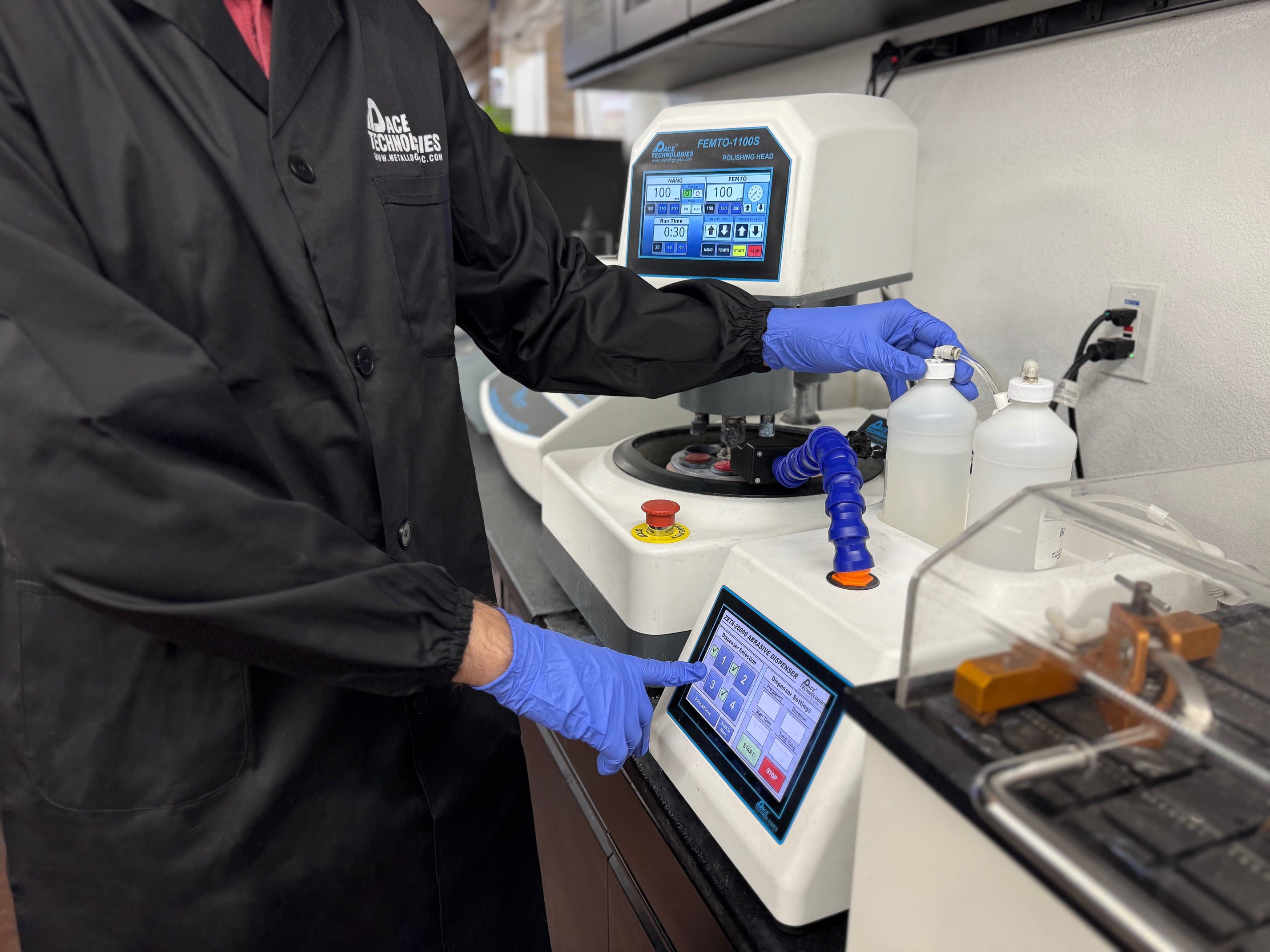 Metallography technician working with sample preparation equipment including grinding polishing machines for metallographic analysis