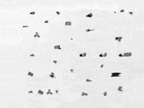 Oxide inclusions in steel microstructure showing common metallographic sample preparation issues and defects in microstructural analysis